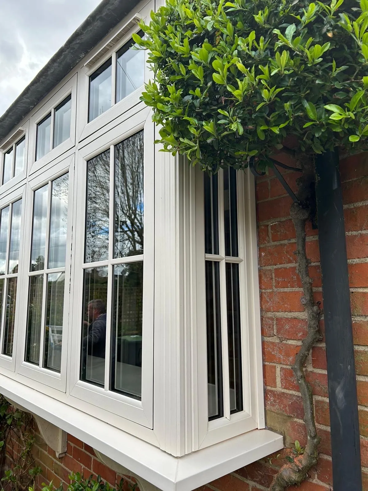 Tall white uPVC windows in red brickwork, viewed from the side